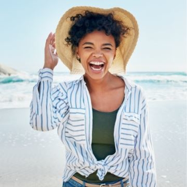 A women smiling at the beach