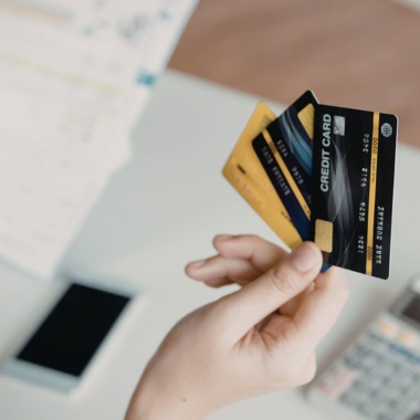 Person holding multiple credit cards
