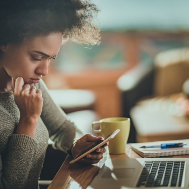 A women looking concerned at her phone