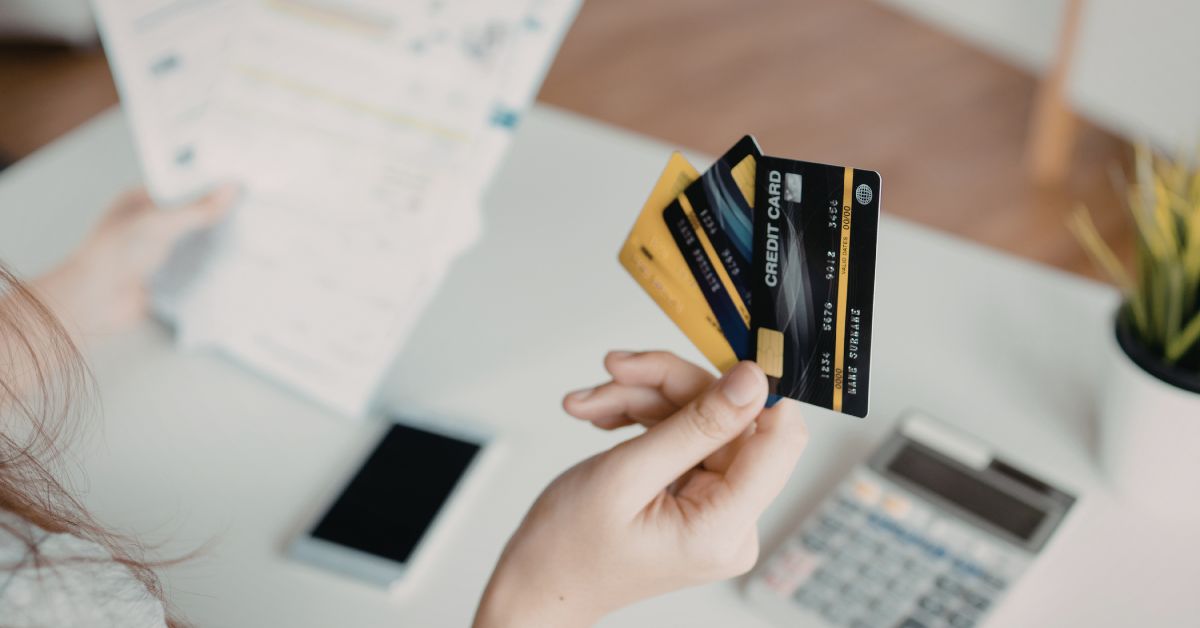 Person holding multiple credit cards
