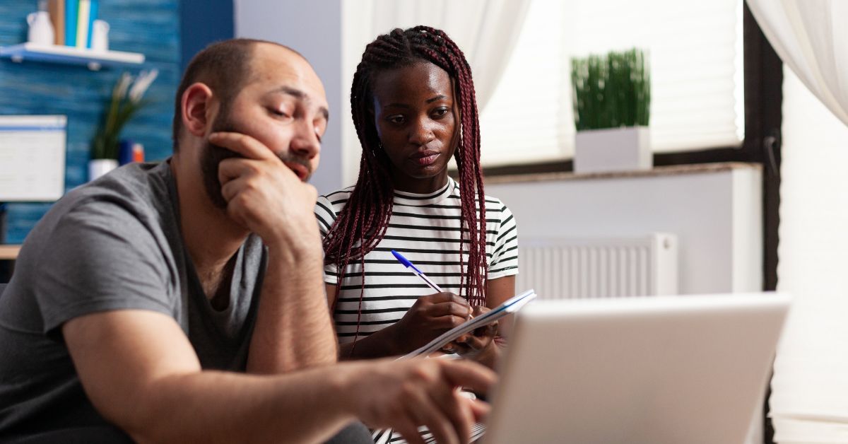 man and woman looking at laptop