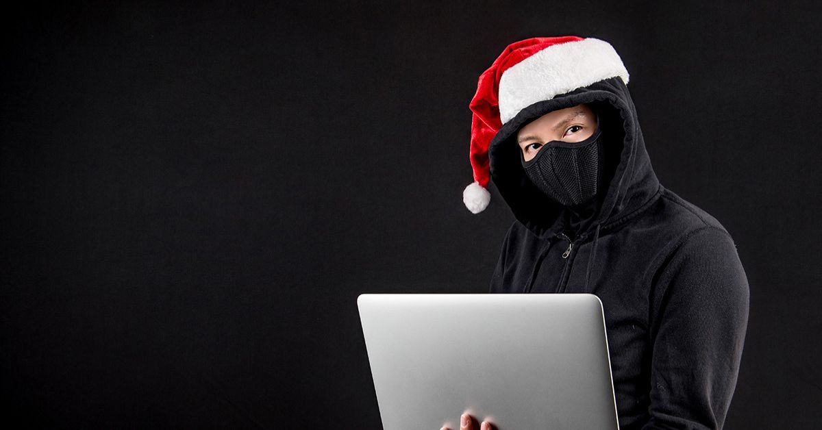 Thief with laptop and Christmas hat