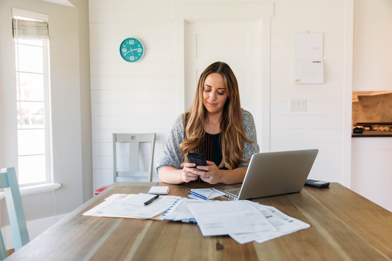 Woman sitting at a table doing finances