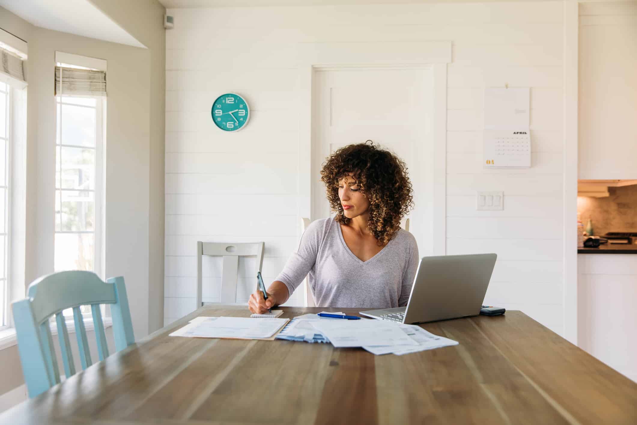 Woman sitting at table doing finances