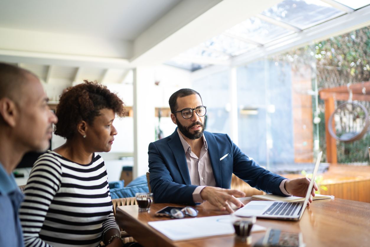 Couple sitting down with an attorney discussing finances