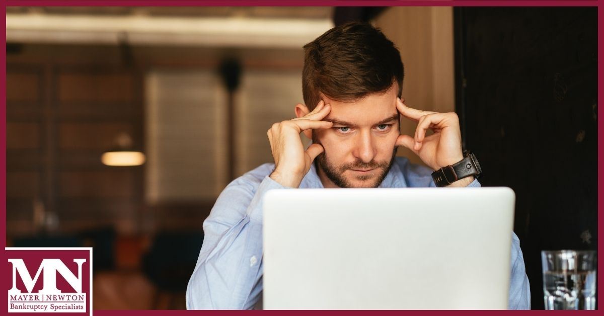 Man worried looking at laptop