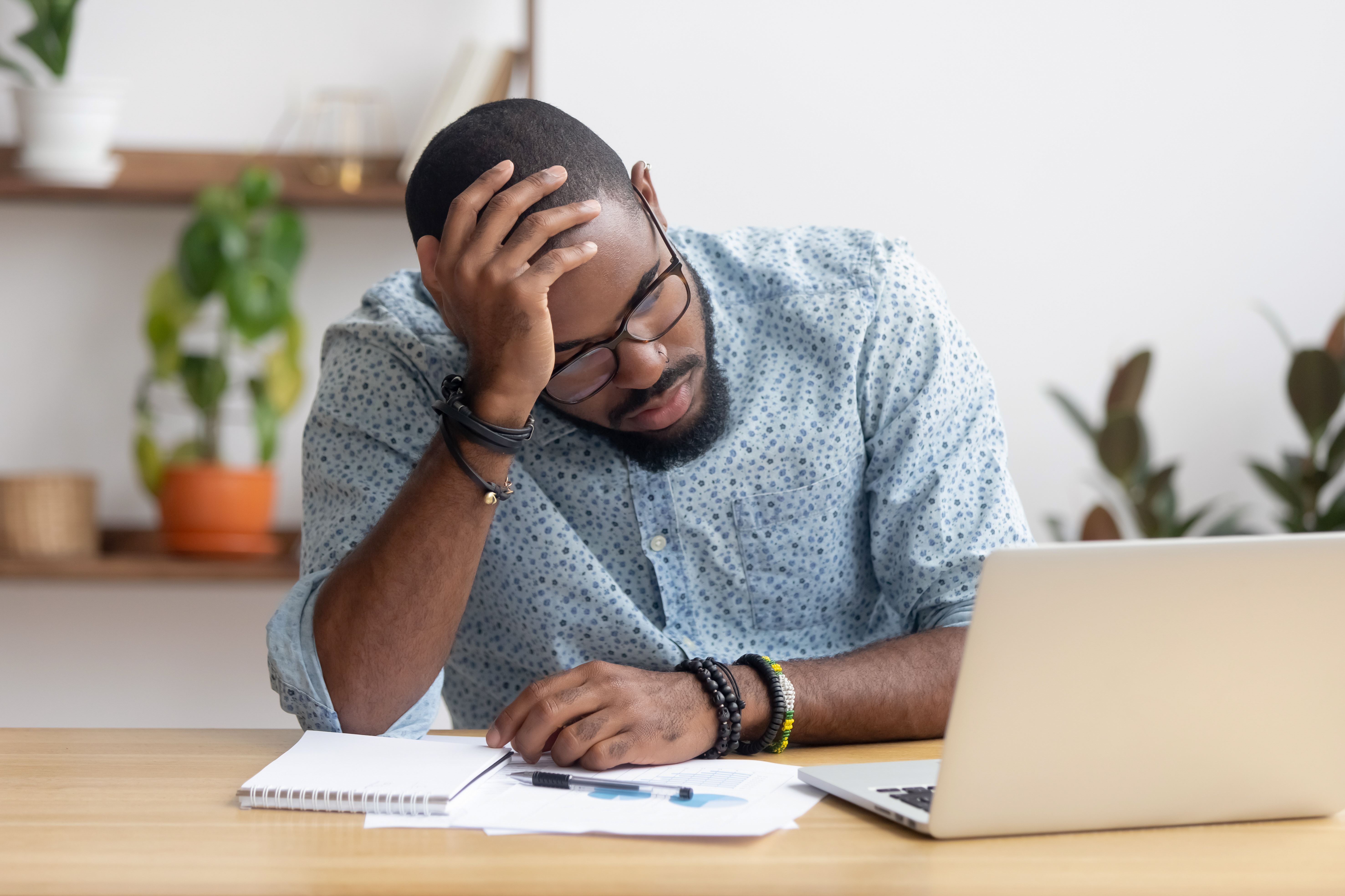 Man looking at computer screen worried