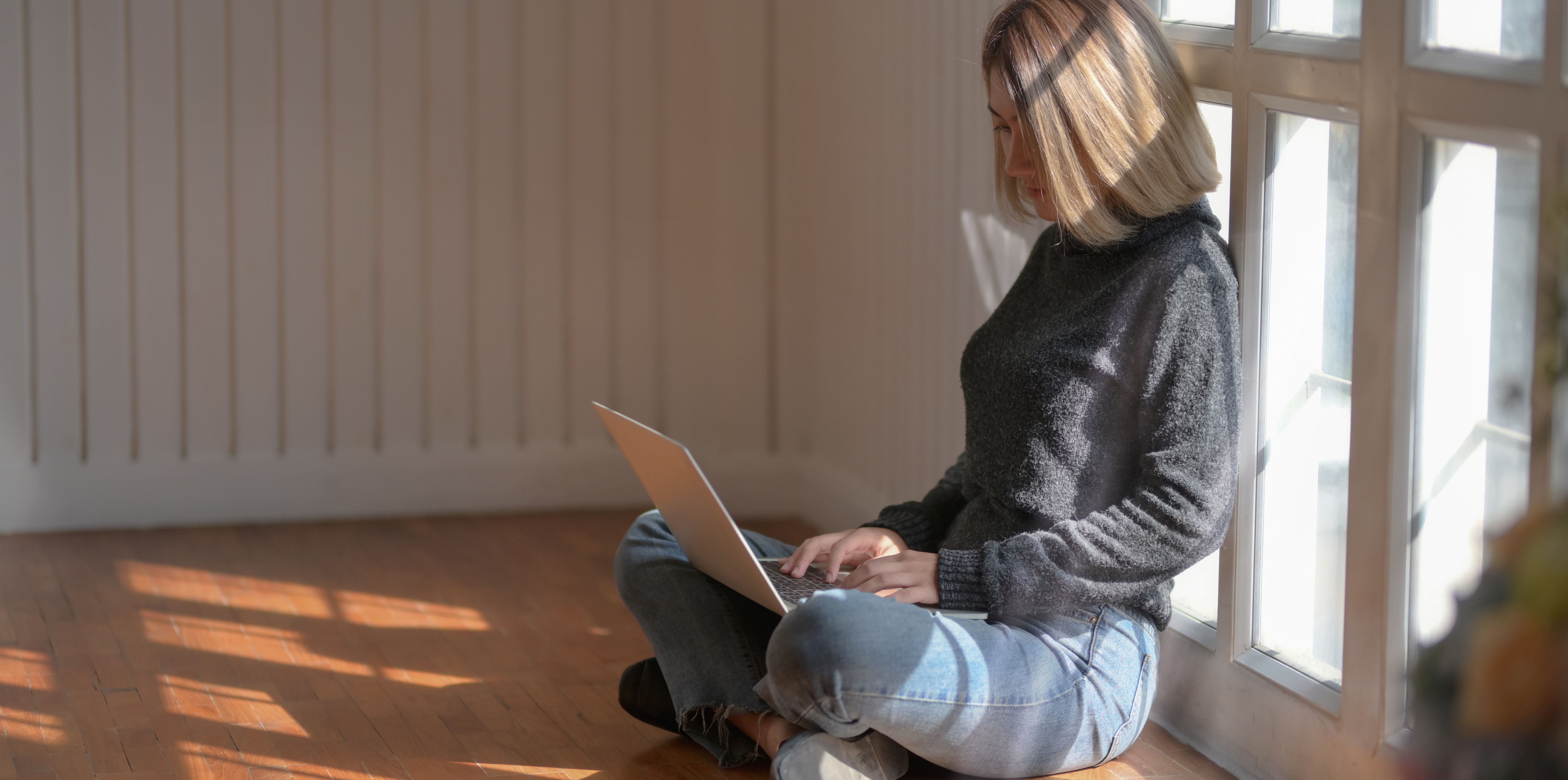 woman sitting looking at laptop